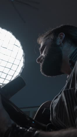 male musician singing into a microphone