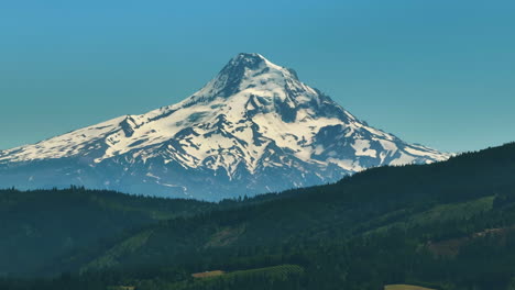 aerial telephoto shot of the snowy mount hood mountain, summer in oregon, usa