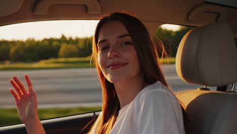 young woman enjoying a sunset road trip with wind in her hair