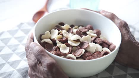 elderly person eating cereal