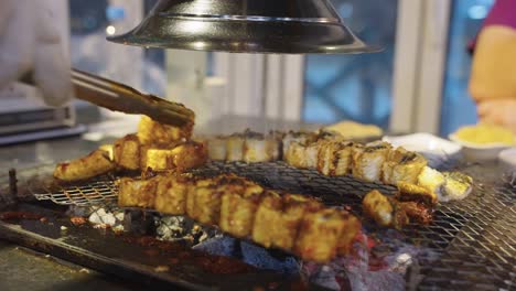 korean eel grilling on barbecue with smoke and coals, busan style jangeo gui