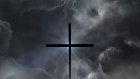 silhouette of a glowing cross against a background of storm clouds