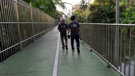 two people walking together on a bike path