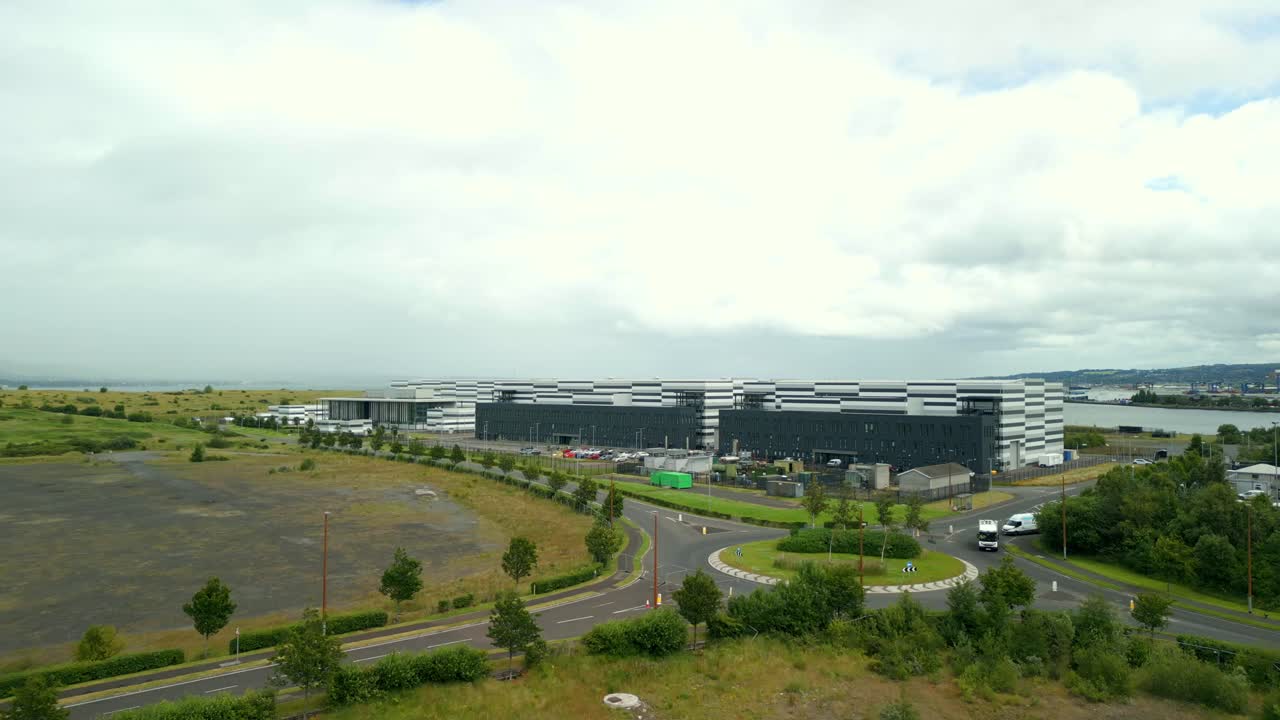 Low, ultra-wide aerial video GV of Studio Ulster, a virtual production film studio in Belfast, Northern Ireland, UK. Filmed in 60FPS, 4K and with Rec709 color