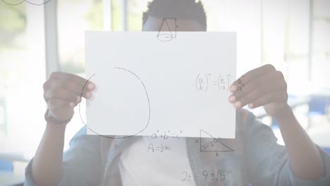ecuaciones matemáticas flotando contra un niño afroamericano con un papel en la escuela primaria