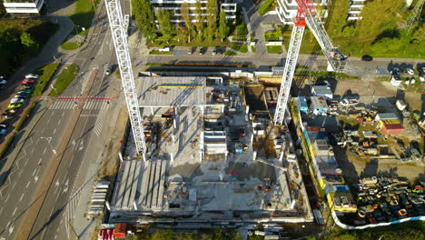 Construction-Site-With-Tower-Cranes-On-A-Sunny-Day-In-The-City-Of-Gdynia,-Pomeranian-Voivodeship,-Poland