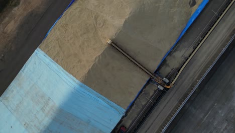 grain unloading for distribution industry. aerial top-down orbiting