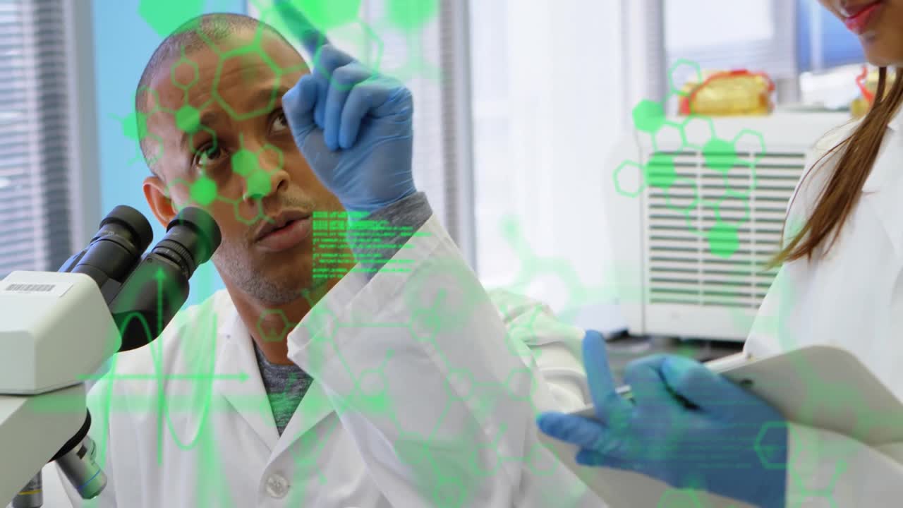 Male scientist adjusting microscope focus in tech lab causing molecular overlay, peer noting data