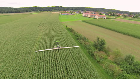 Sprayer-moving-through-corn-field,-applying-crop-protection