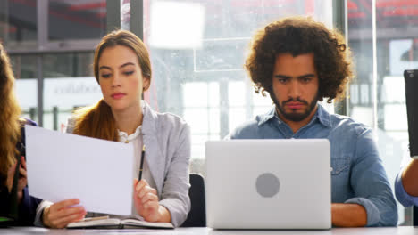 ejecutivos de negocios que usan computadoras portátiles y tabletas digitales en reuniones