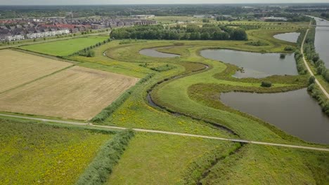 Aerial-drone-view-of-the-beautiful-watery-landscape-and-big-canal-in-the-Netherlands,-Europe