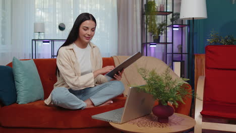 Young-businesswoman-working-with-laptop-computer-and-documents,-planning-expenses-budget-at-home