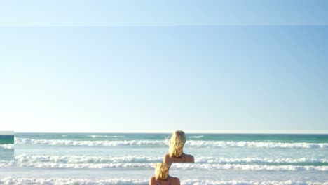 Woman-standing-on-shore-at-beach-on-a-sunny-day