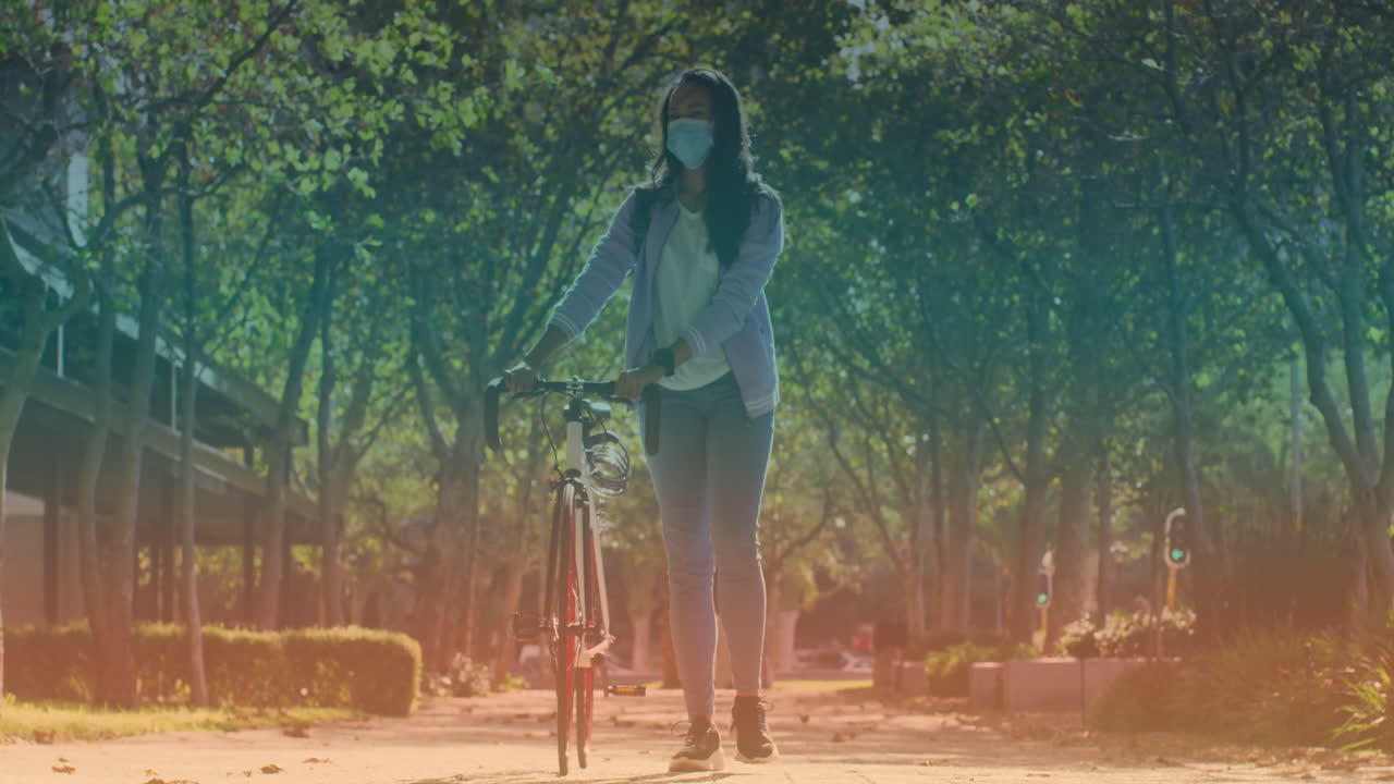 얼굴 마스크를 쓰고 자전거를 타고 는 두 인종의 여성의 애니메이션