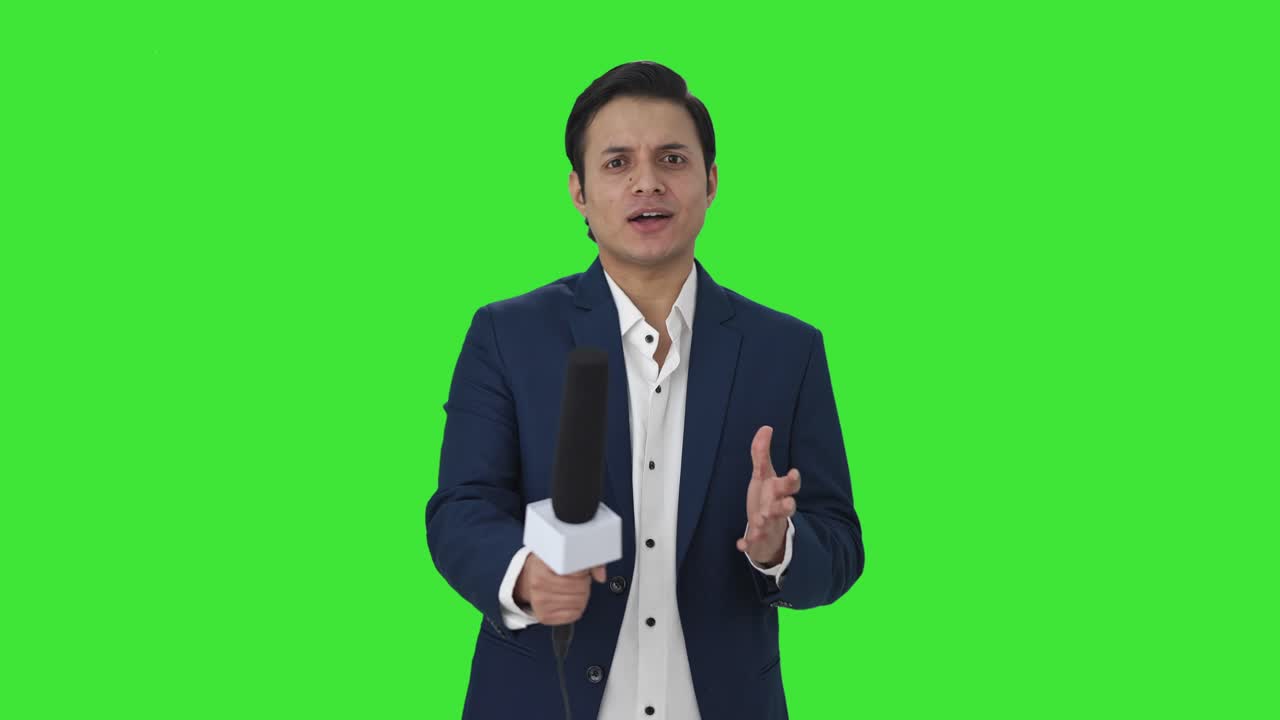 Happy Indian reporter asking questions Green screen