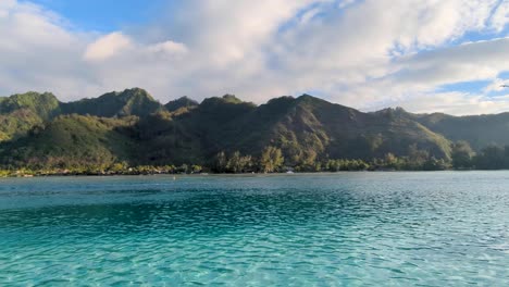 Scenic view of rugged mountainous landscape and turquoise ocean water on tropical island of Moorea in French Polynesia, South Pacific