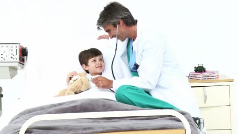 Mature-doctor-playing-with-a-little-boy