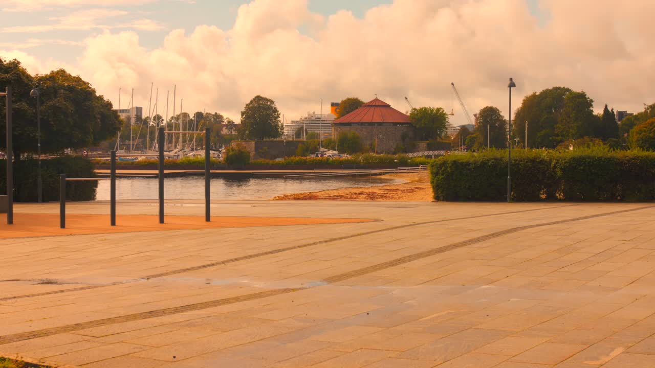 A ground-level view of the historic round Christiansholm Fortress next to a harbor and marina in the Kristiansand city center, Norway