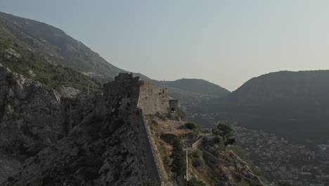 the ancient walls along the mountains in kotor, montenegro. the ramparts have positions at various points; within them is a network of communications as well as additional buildings