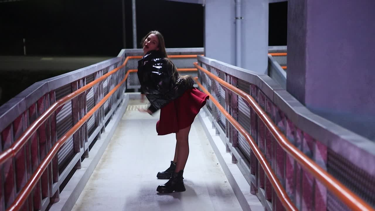 Young talented dancer dancing alone at night in urban area