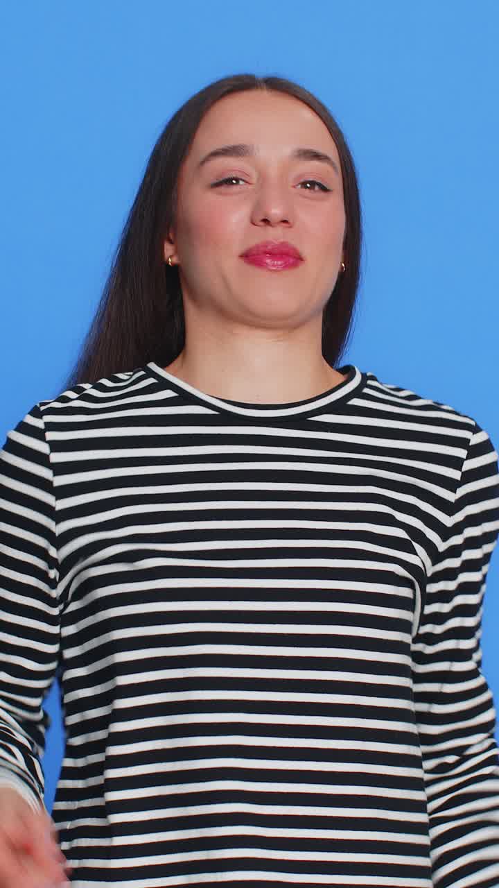 Happy woman showing rock n roll gesture by hands cool sign crazy expression dancing victory win