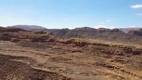 Revealing-aerial-as-the-vast-expanse-of-Sinai's-desert-landscape-in-Egypt-unfolds,-illustrating-the-concept-of-rugged-beauty-and-untamed-wilderness