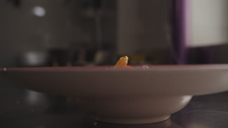 adding an ingredient to a bowl or plate during food preparation