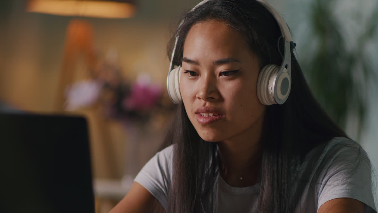 Woman Working on Computer with Headphones