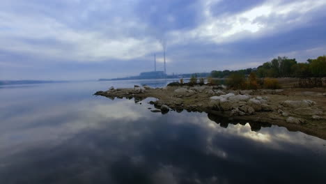 lake scenery with power plant in the background