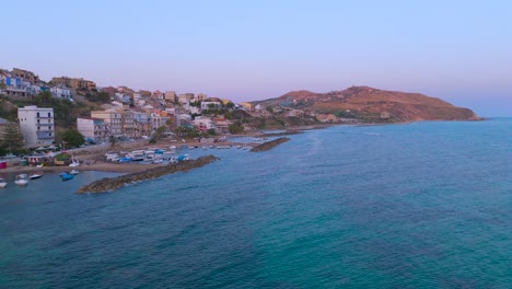drone shot capturing a town located at marina di palma in sicilia. turquoise water sea