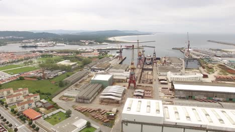 Flying-Over-Shipyard-with-Cranes-and-Boat