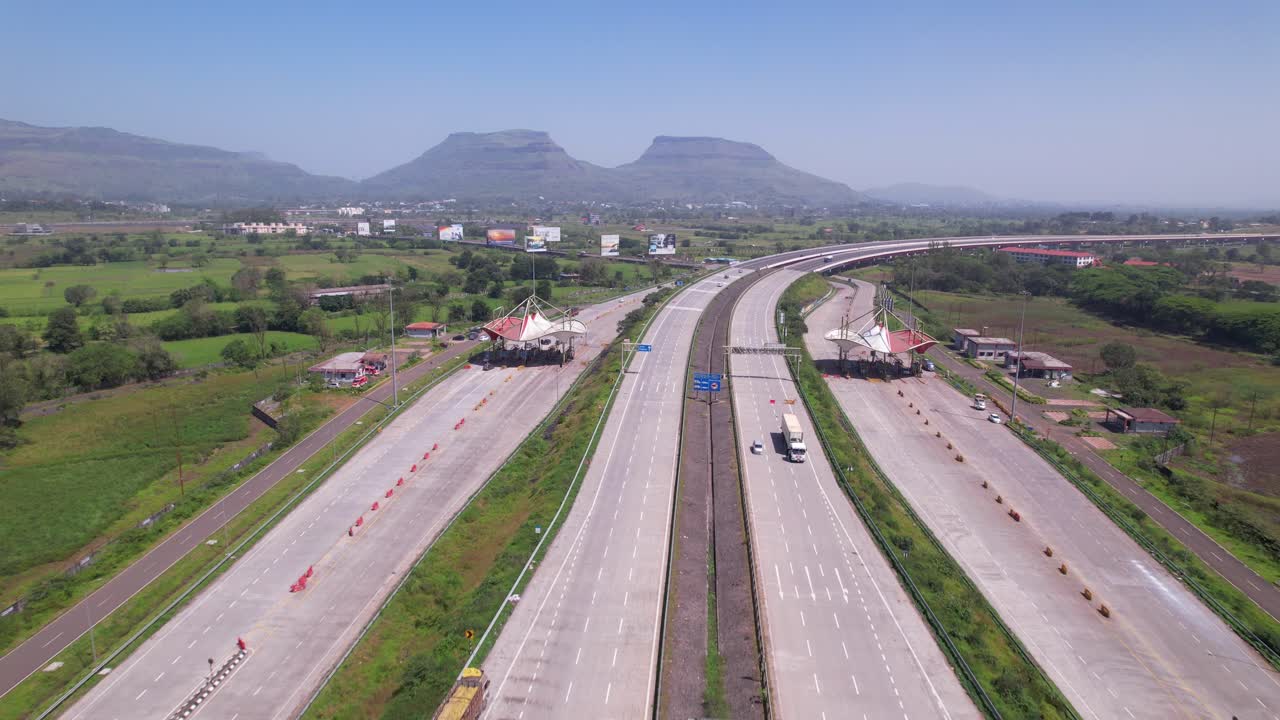Samruddhi Mahamarg expressway toll station connecting Mumbai and Nagpur through fertile agricultural fields, Maharashtra, Drone shot