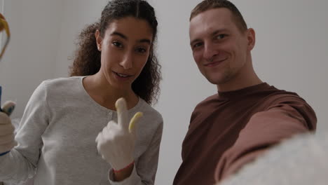 Happy Couple Painting Their New Home - DIY Home Improvement Project