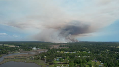 wide drone shot of a forest fire, panning from right to left