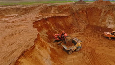 Mining excavator working at sand quarry. Mining industry