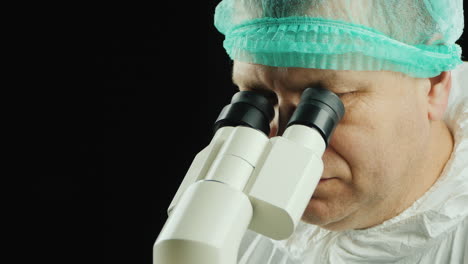 portrait of a scientist working with a microscope in the lab