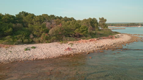 Turistas-En-La-Costa-Rocosa-Con-Bosque-Con-Vegetación-En-Verano-En-Croacia