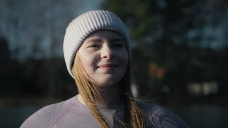 caucasian woman taking a breath in winter and turning into the sun.