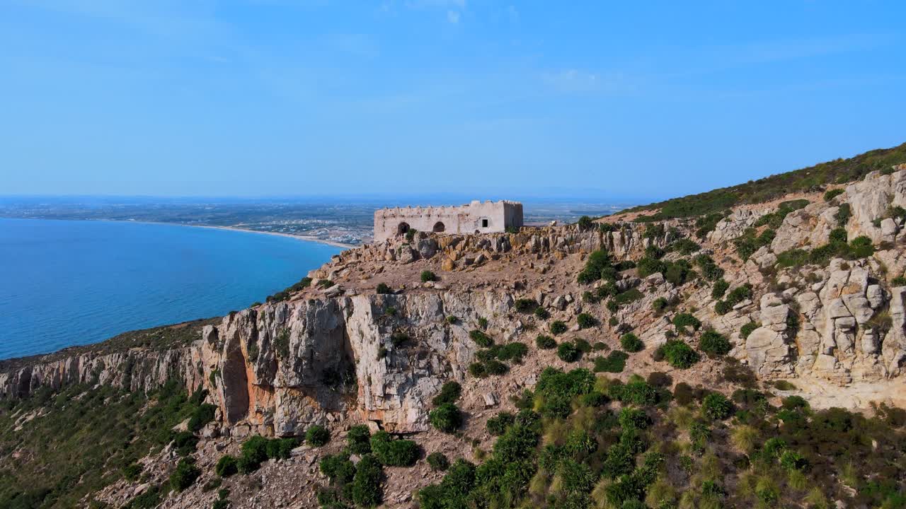 A sweeping coastal landscape featuring rugged cliffs, a historic fortification, and the vast horizon where sea meets sky, evoking a sense of timeless mystery.