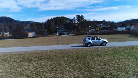 fast drone shot of a driving car from the side, 4k uhd