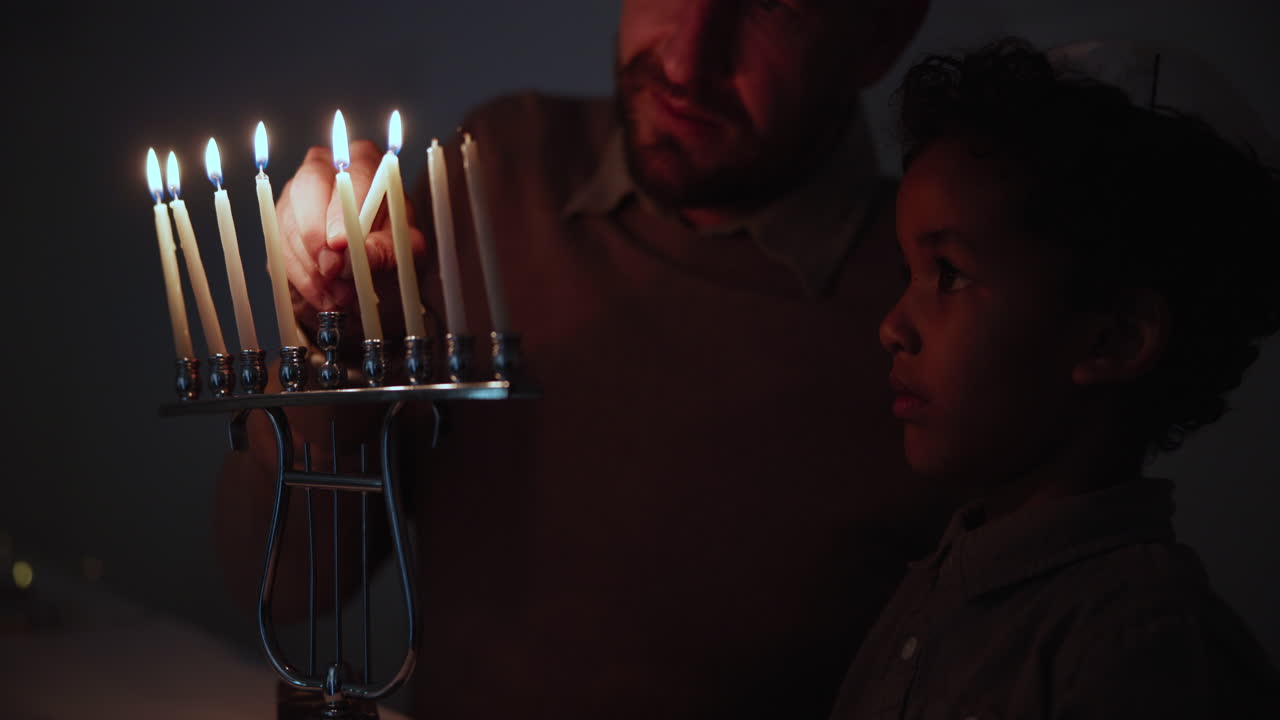 Jewish, religion and a family lighting candles