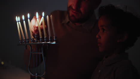 jewish, religion and a family lighting candles