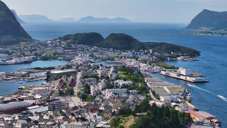 aerial view of alesund, norway, cityscape and bay between islands, drone shot