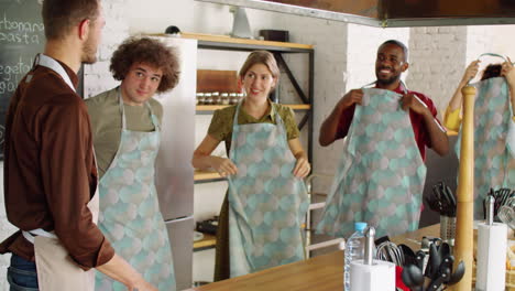 cheerful multiethnic people preparing for culinary master class