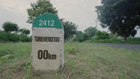 highway milestone showing distance of turkmenistan