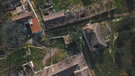 Aerial-view-of-an-abandoned-village-with-a-church-surrounded-by-nature-in-Spain