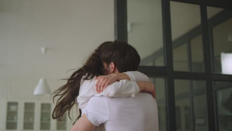 Closeup-happy-couple-embracing-in-slow-motion.-Smiling-lovers-spinning-around