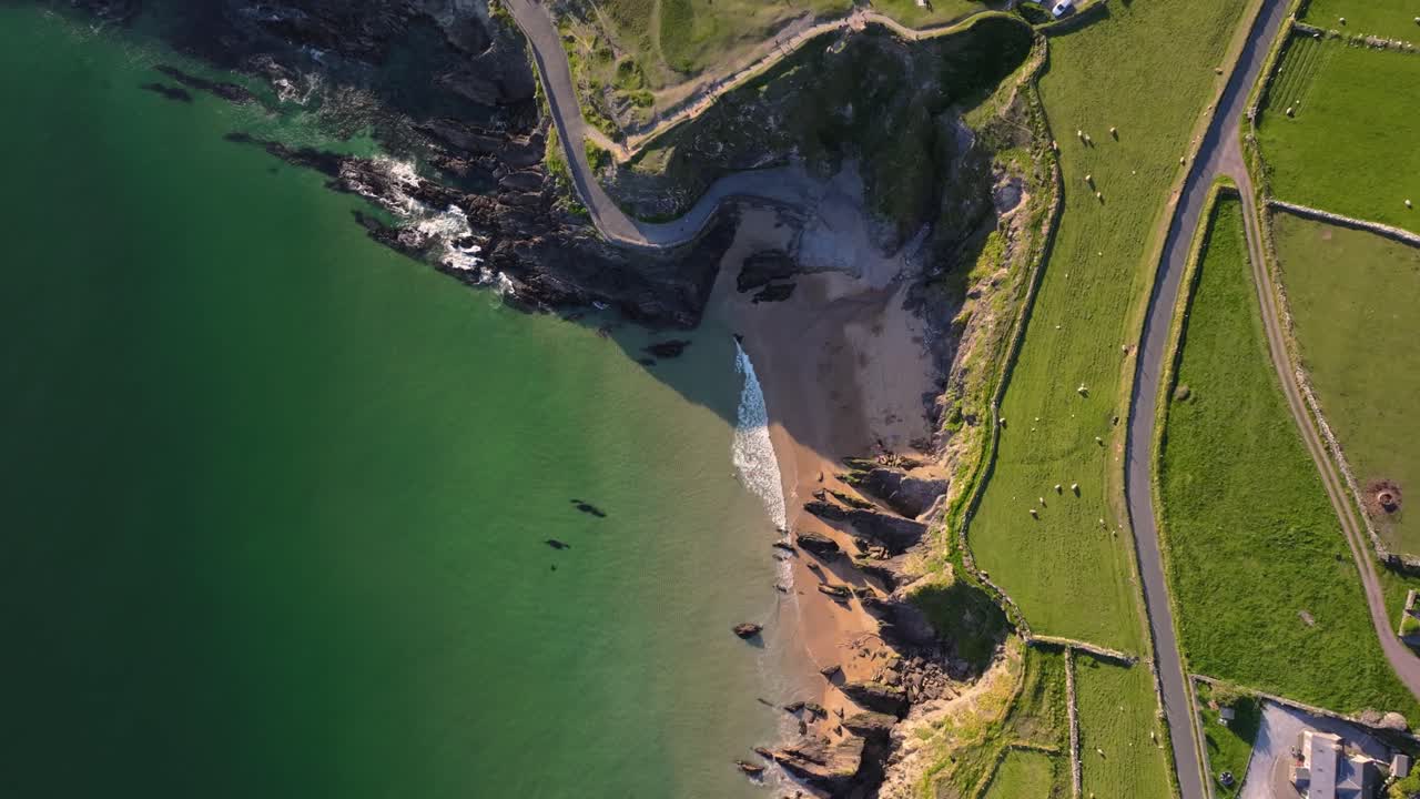 Coumeenoole Beach glowing under bright sunshine, with clear skies and turquoise waves - Dingle Co.Kerry - 4K Cinematic Drone Footage 05