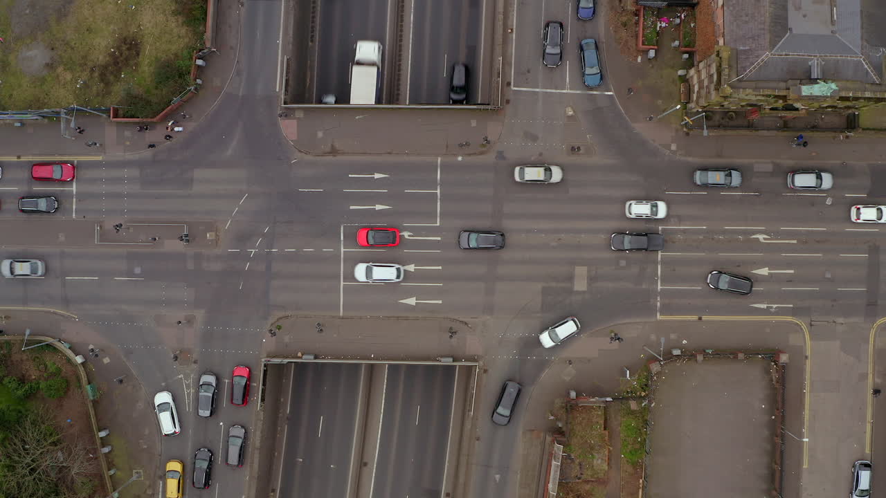 Bird's-eye timelapse of bustling Belfast intersection capturing the rhythmic flow of city traffic