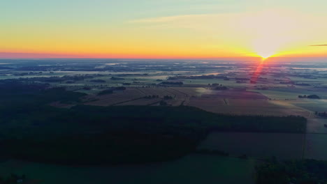 aerial panoramic view of faded sunset, glow vivid light over forestry